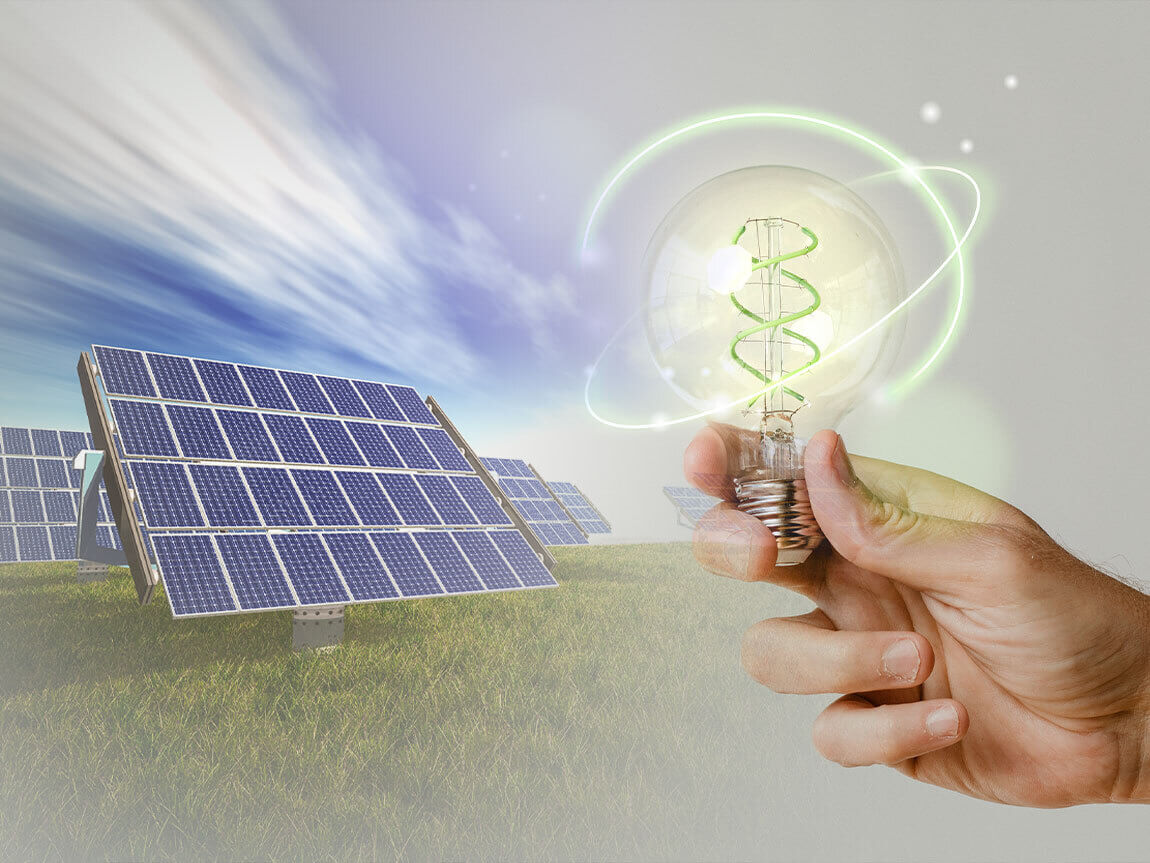 solar panels and an electric bulb in a human hand